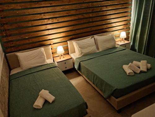 a bedroom with two beds with towels on them at Litsa's House Platanias in Agia Paraskevi