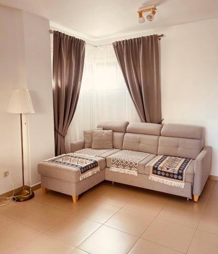 a living room with a couch and a window at Santa Clotilde in Lloret de Mar