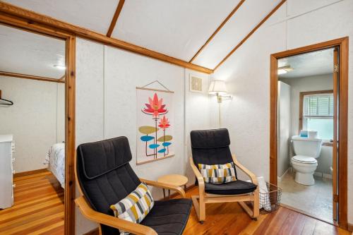a living room with two chairs and a toilet at Fish Creek Cottages in Fish Creek
