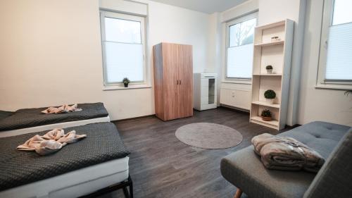 a living room with two beds and a couch at FlexHome Gemütliche Ferienwohnung in Lippstadt