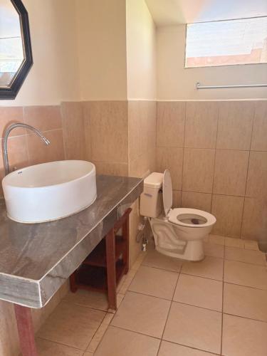 a bathroom with a sink and a toilet at Beautiful Second Story Apartment 202 Next to Playa Flamingo in Playa Flamingo