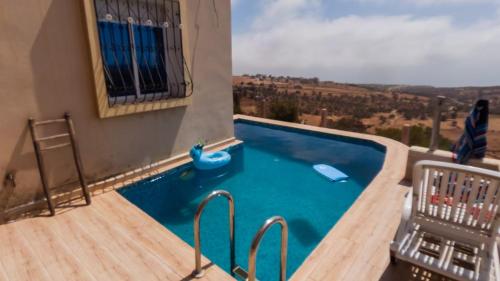 a swimming pool with a slide in a house at La Cabane Surf Lodge in Agadir