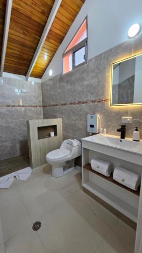 a bathroom with a toilet and a sink at HOTEL MILLA SUITES MERIDA in Mérida
