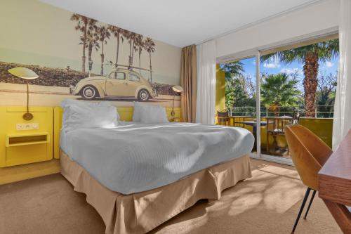 a bedroom with a bed with a car on the wall at Hotel Casarose - Cannes Mandelieu in Mandelieu-La Napoule