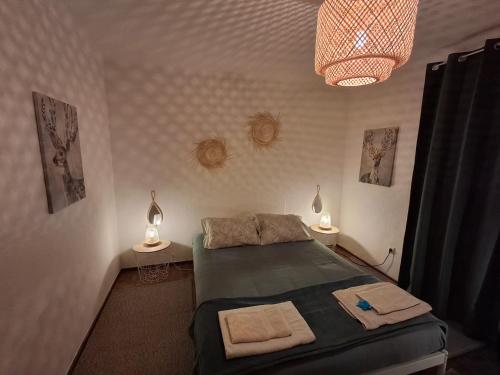 a bedroom with a bed and two tables with lamps at Refúgio de Arez-Alojamento Local in Arez