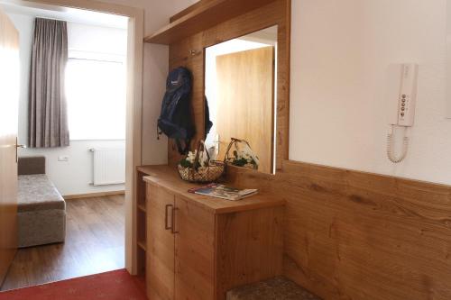 a room with a mirror and a wooden cabinet at Amontanara in Nauders