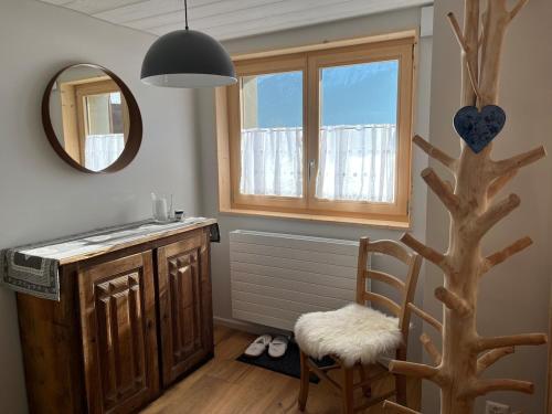 a bathroom with a sink and a tree with a mirror at Chalet Les Marmouzets in Gryon