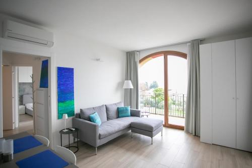 a living room with a couch and a large window at Marion's Apartment in Riva di Solto