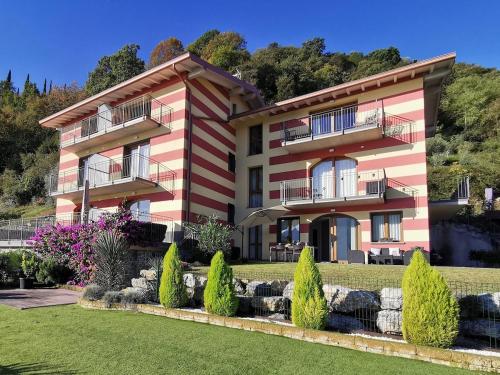 a large house with a garden in front of it at Marion's Apartment in Riva di Solto