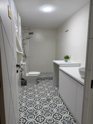 a bathroom with a toilet and a sink and a tub at Amavilla Hotel in Telavi