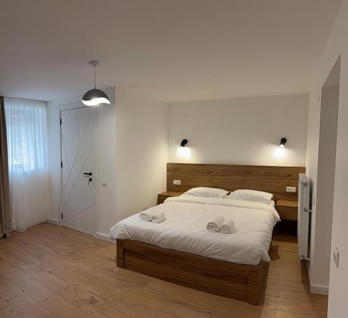 a bedroom with a large bed with white sheets at Amavilla Hotel in Telavi