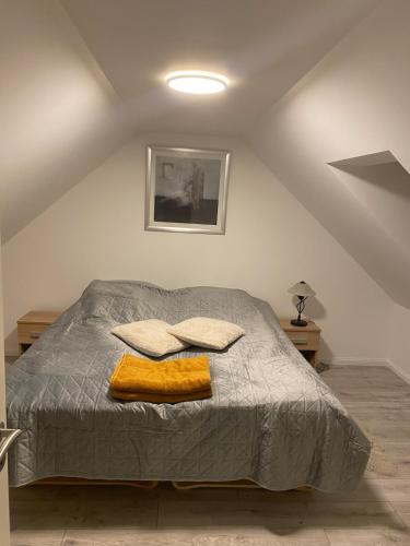 a bedroom with a bed with two pillows on it at House overlooking the countryside and close to the city in Middelfart
