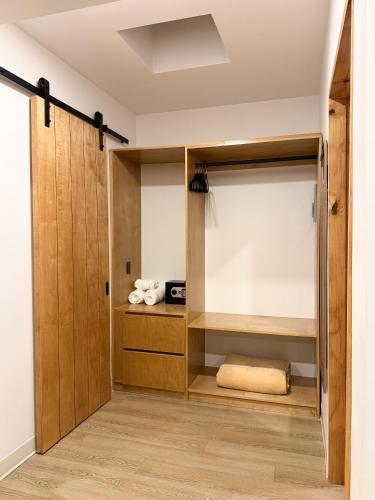 a room with a closet with wooden doors at Castillo Toscana Hotel Boutique in Ensenada