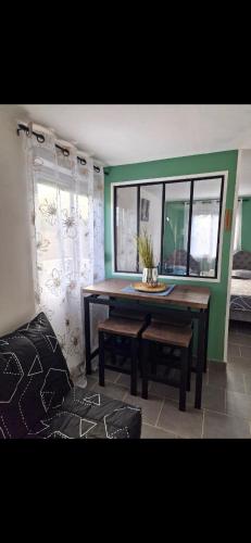 a dining room with a table and a window at La jonquiere etablisement climatisé in Landouzy-la-Cour