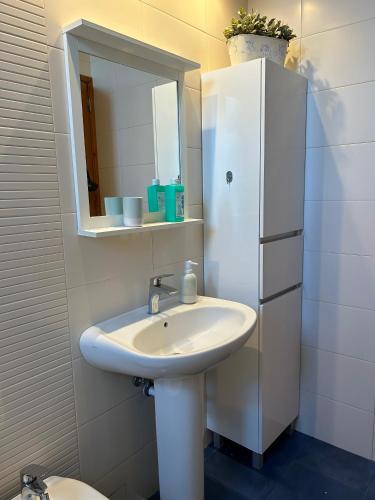 a bathroom with a sink and a mirror at Casa da Avó - Vila do Porto in Vila do Porto