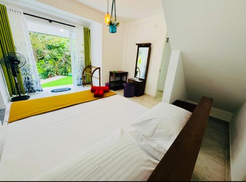 a bedroom with a large white bed and a window at 35-B-5 Kandy in Kandy