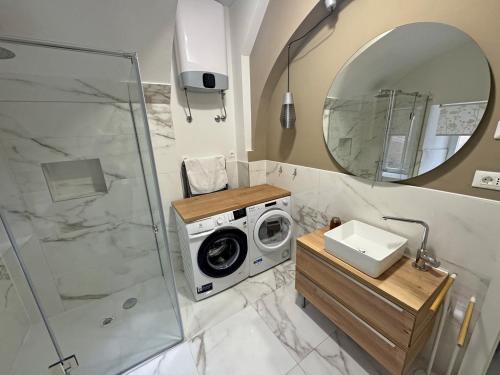 a bathroom with a washing machine and a mirror at Premium Zec by Pag tours in Pag