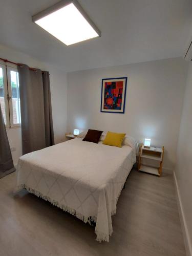 a bedroom with a large bed with yellow pillows at La Casa de Mirna II in Formosa