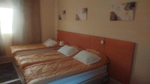 two twin beds in a small room with twoermottermott at EL Salam in Hotel Apartment 6 in Sharjah
