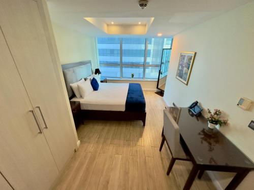 a hotel room with a bed and a large window at One Bedroom apartment Centaurus Islamabad in Islamabad