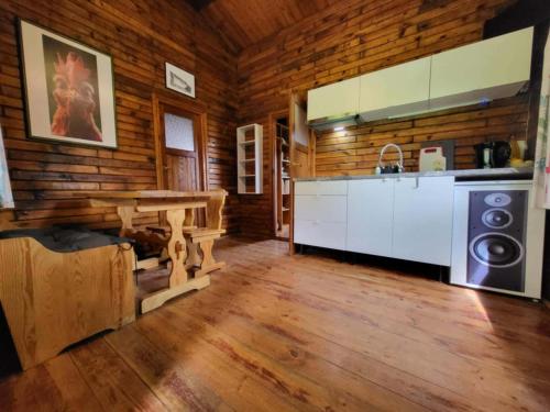 a kitchen in a log cabin with a table at Domek "Sen 100 Jezior" in Chrzypsko Wielkie