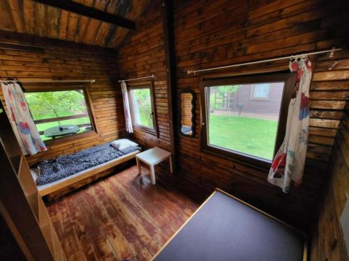 an inside view of a log cabin with two windows at Domek "Sen 100 Jezior" in Chrzypsko Wielkie