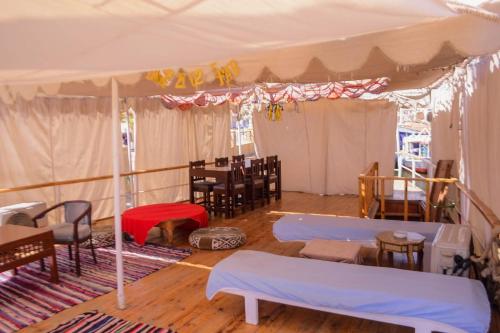 a room with a tent with tables and chairs at 1Water Lily in Luxor