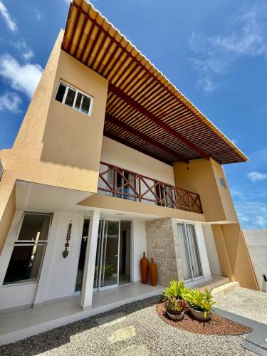 a house with a balcony on top of it at Pipa Sunset Mansion in Pipa