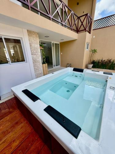 a hot tub in the middle of a house at Pipa Sunset Mansion in Pipa