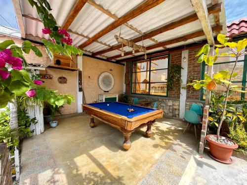 a pool table in the middle of a patio at Nativo Lodge in Playas