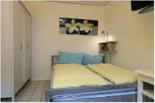 a bedroom with a bed and a picture on the wall at wohnung-nr-2 in Kirchzarten