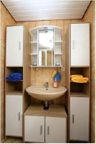 a bathroom with a sink and white cabinets at wohnung-nr-2 in Kirchzarten