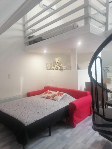 a bedroom with a red bed with a teddy bear on the wall at La tour du bonheur in Mantry