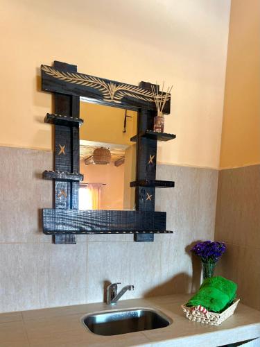 a bathroom sink with a mirror over a sink at Casa Mamani in Tilcara