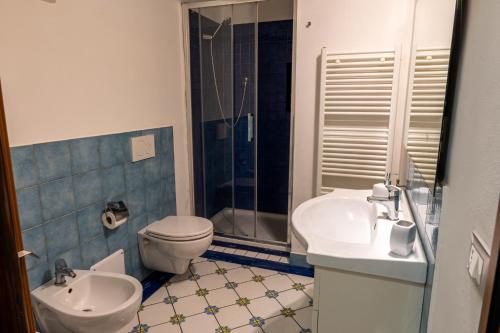 a bathroom with a toilet and a sink and a shower at Suite Cerchio 2 - City Center in Ravenna