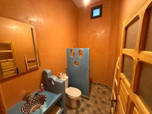 a bathroom with a toilet and a sink and a shower at Dar Talhaya in Oulad Driss