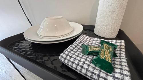 a table with a plate and a towel on it at Peace and quiet on the beautiful North Shore in Auckland