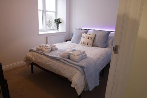 a bedroom with a bed with towels on it at Converted Coastal Coach House in Weston-super-Mare