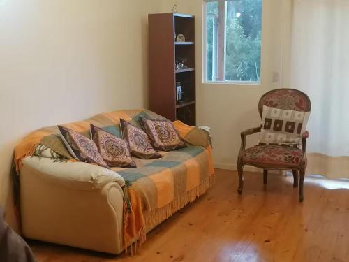 a bedroom with a bed and a chair at Puyehue in Mantilhue