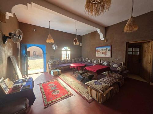 a living room with a couch and a table at Dar Talhaya in Oulad Driss