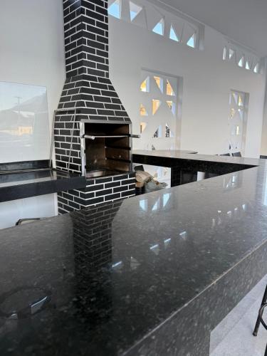 a fireplace on top of a table in a room at Brisa Mar Prime in Porto Seguro