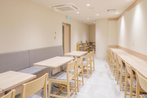 a row of tables and chairs in a room at Tosei Hotel Cocone Kamata in Tokyo