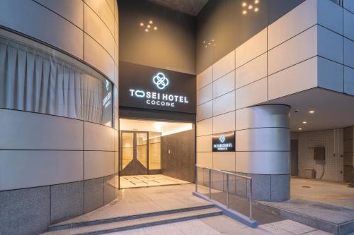a building with a tesla hotel sign on it at Tosei Hotel Cocone Kamata in Tokyo
