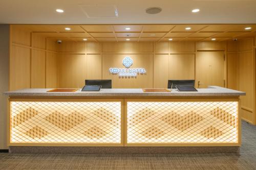 a lobby with a reception desk in a building at Tosei Hotel Cocone Kamata in Tokyo