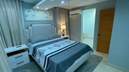 a bedroom with a king sized bed in a room at Dgomez House in Santiago de los Caballeros