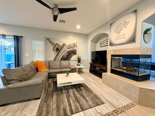 a living room with a couch and a fireplace at Oasis pool house, optional pool heater in Las Vegas