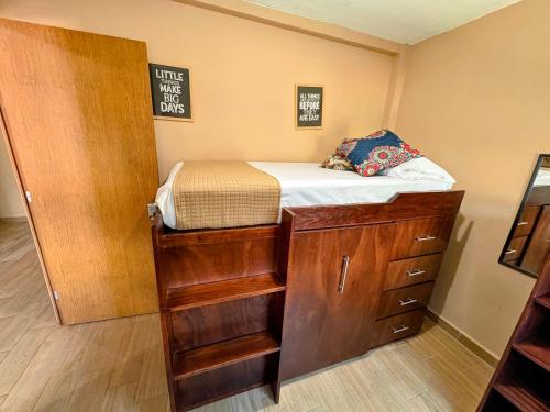 a small bedroom with a bed and a closet at Estancia Punto Coliving Estadio in Morelia