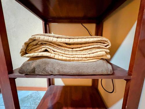a stack of towels sitting on a shelf at Estancia Punto Coliving Estadio in Morelia
