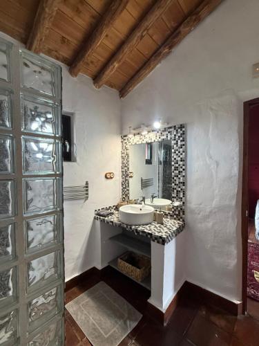 a bathroom with a sink and a mirror at La Guzmana de Ronda in Ronda