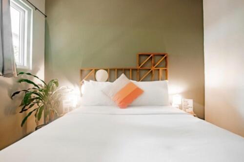 a bedroom with a large bed with white pillows at Selina Venao Beach West in Playa Venao